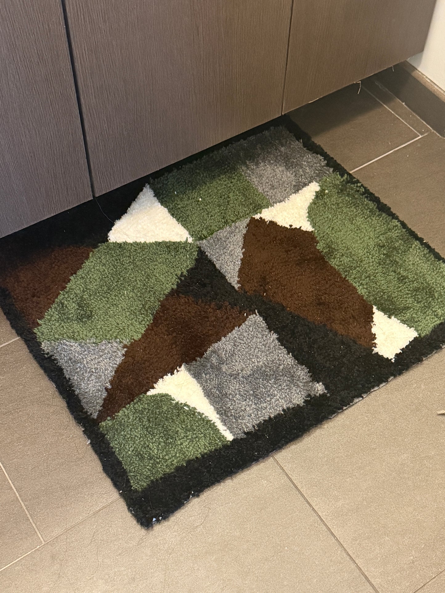 Geometric patterned rug on a tiled floor